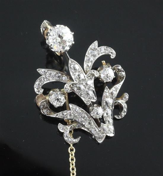 A Victorian style gold and platinum diamond set scrolling pendant brooch, overall 43mm.